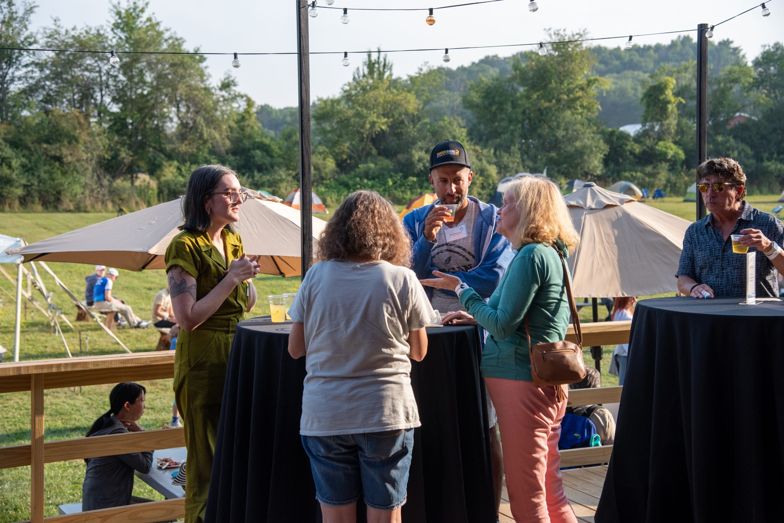 Guests talk around a table at Farm Sanctuary's Hoedown 2025 event