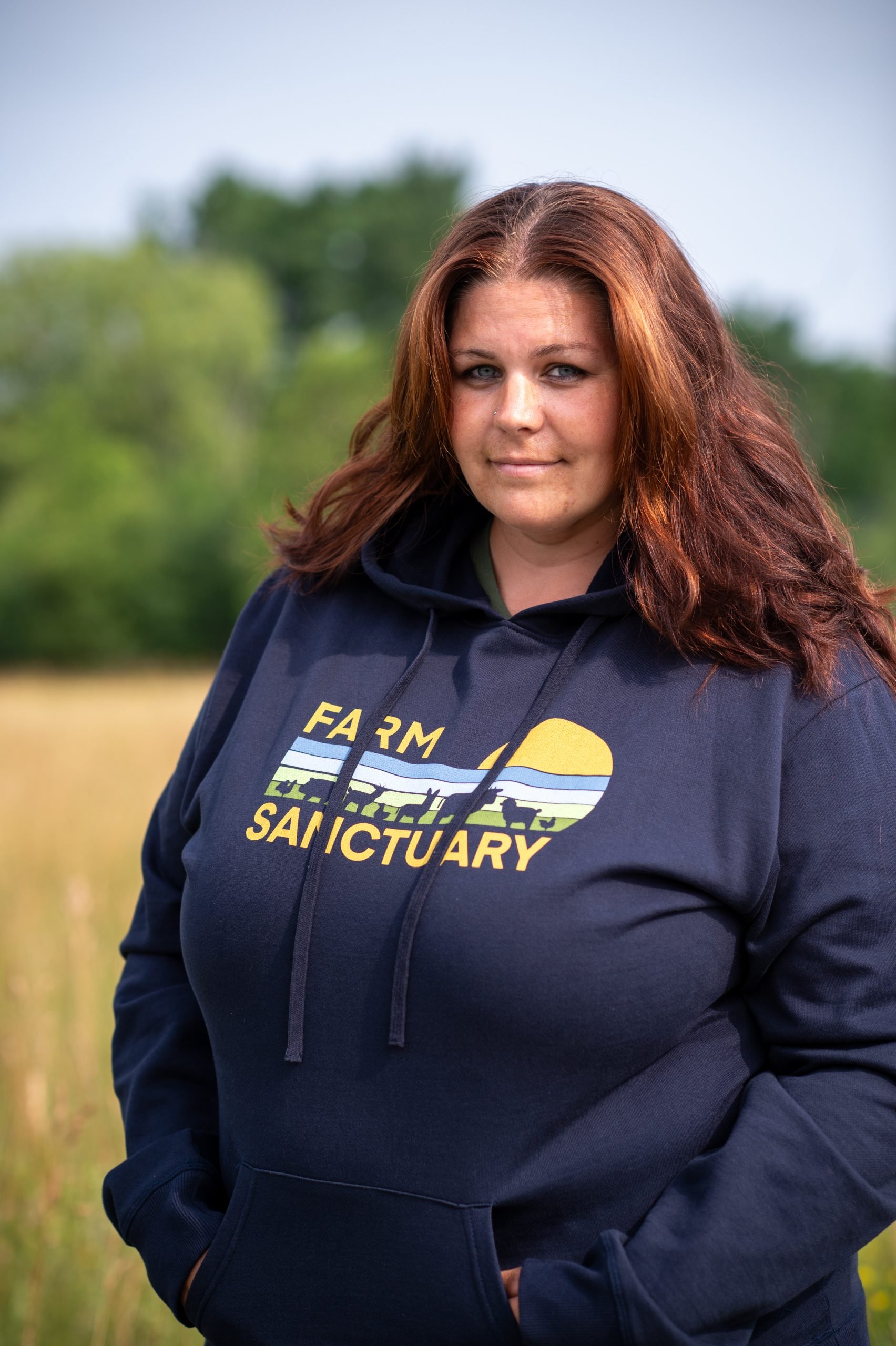 Farm Sanctuary staff Sarah Rappleye wears Farm Sanctuary retro sweatshirt