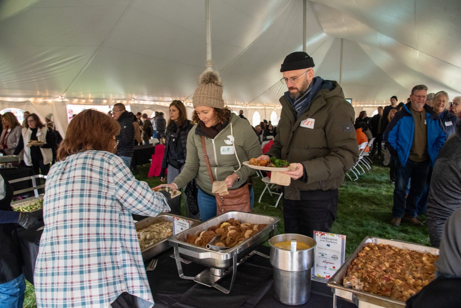 Two guests are served vegan food from hot trays at Farm Sanctuary's Celebration for the Turkeys event