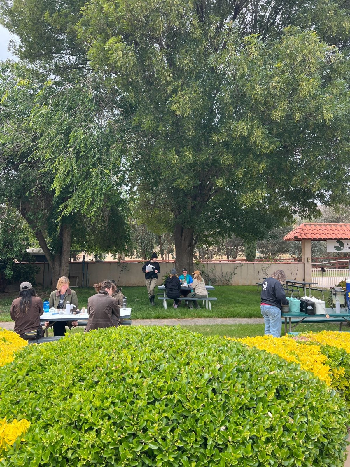Volunteers work on Earth Day projects at tables at Farm Sanctuary