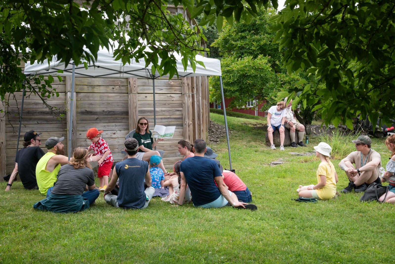 Farm Sanctuary staff Mercy Mize reads to families at the summer Pignic even